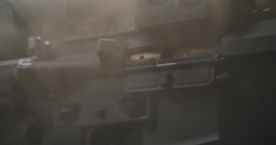 Smoke is surrounding the black rifle