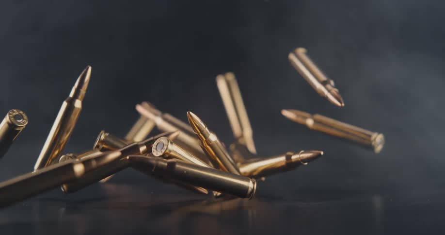 Bullets falling on the floor in a room with smoke