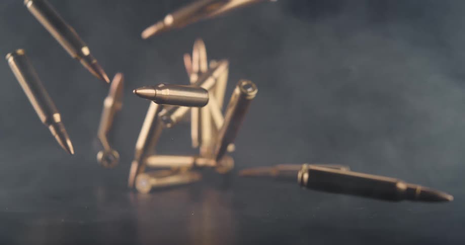Large bullets fall in the smoke filled room