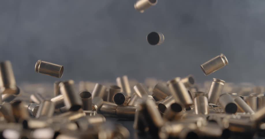 The bullet shells fall and bounce as they land