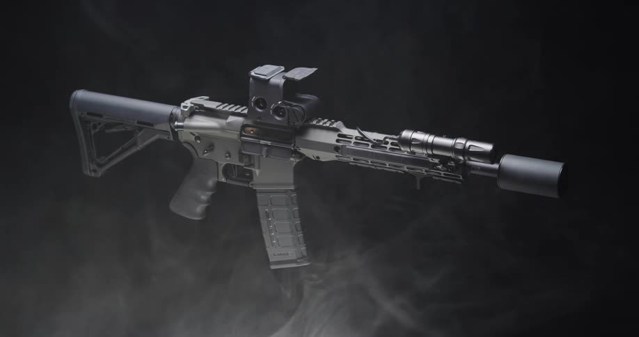 A rifle floats against a black background with smoke swirling around