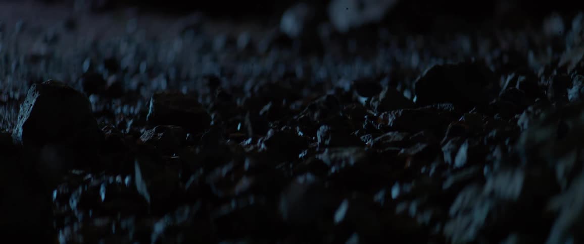 The dirt slowly rises from the dark field