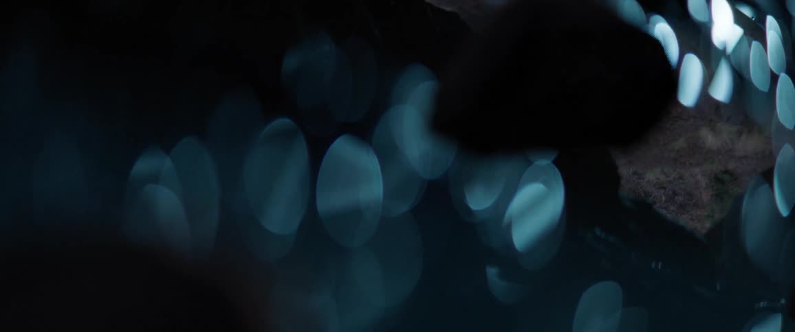 Light glare reflects on water at night