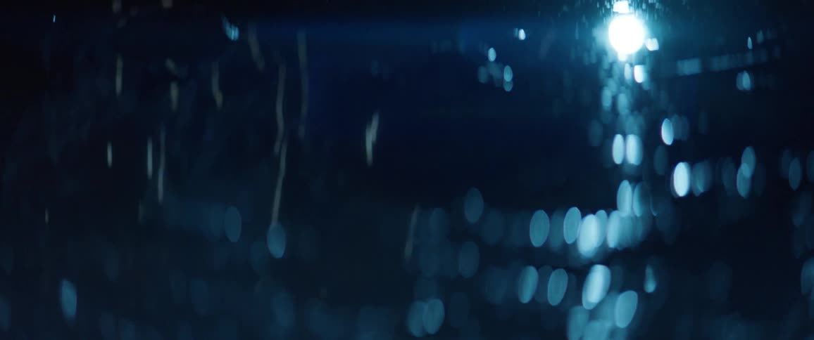 The water reflects the lights in the sky at night
