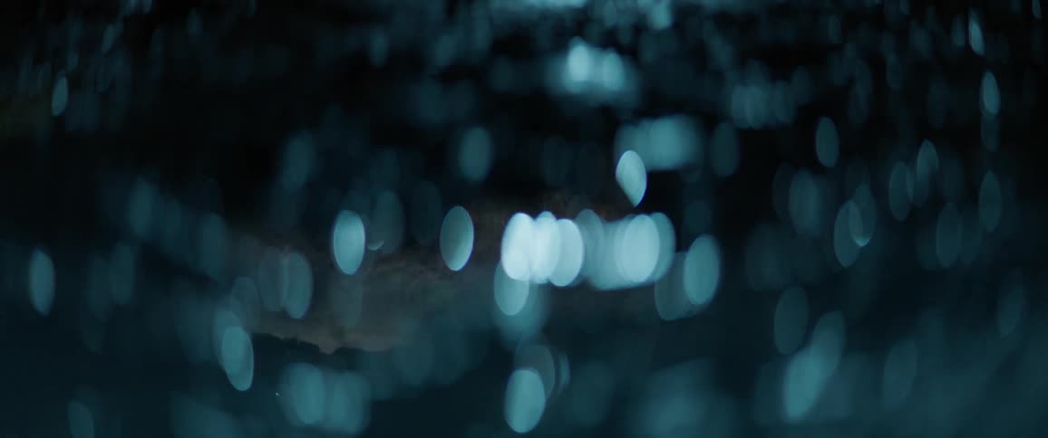 Dots of light shining surrounded by darkness