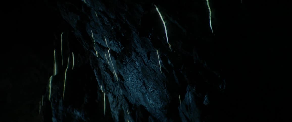 Lights are projected onto a cave wall