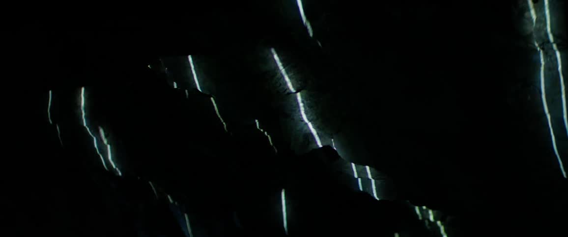 Lights are projected onto a rocky wall