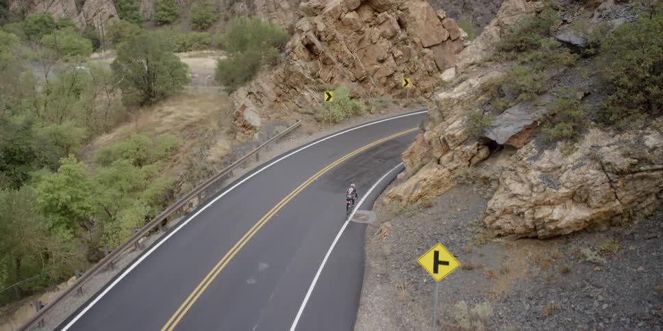 A person rides a bike along a country road