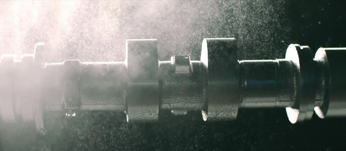 Water spraying on a rotating cylindrical piece of machinery