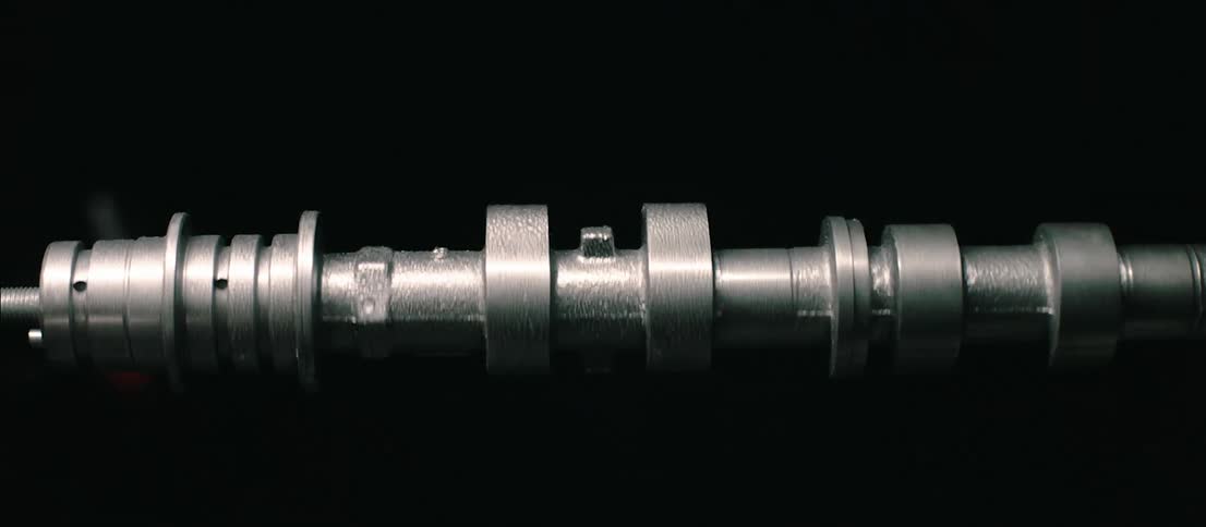 Engine shaft spinning inside a dark room under flashing lights