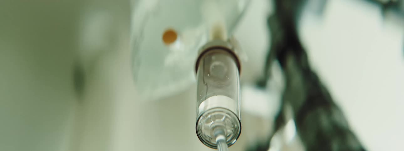 An intravenous bag with medicine drips