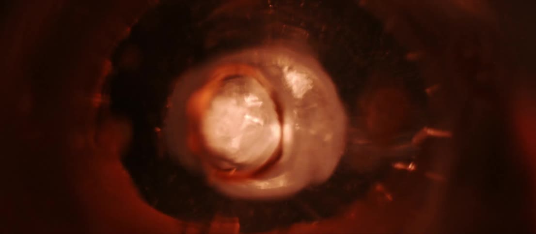 A light amber colored liquid moving around and bubbling