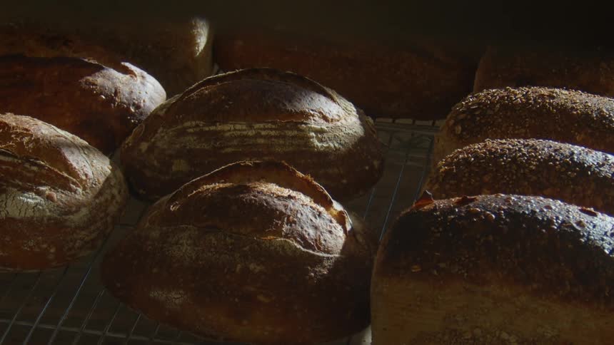 Loaves of bread on shelves in the bakery