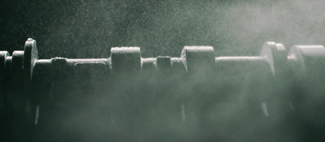 Water spraying over a rotating piece of machinery in the dark