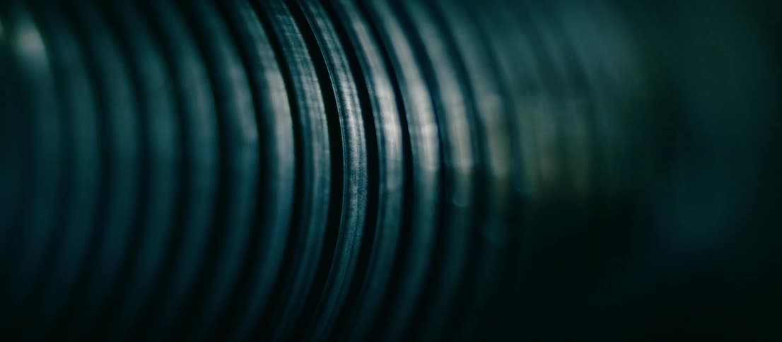 Abstract footage of light flashing on textured metal