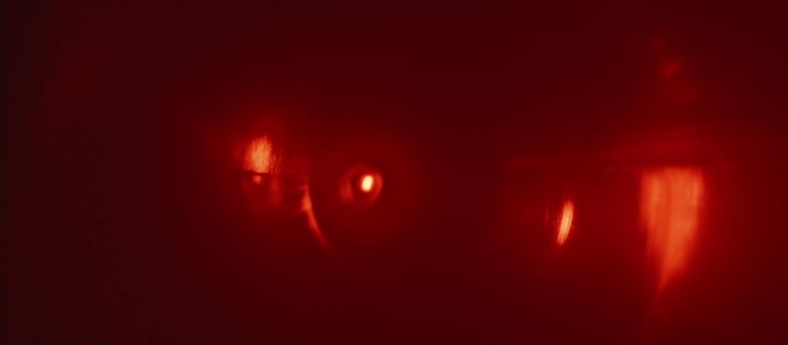 Red lights shining in pitch black