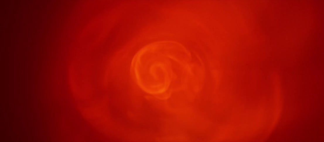 Abstract footage of a bright swirling light that fades out to blackness