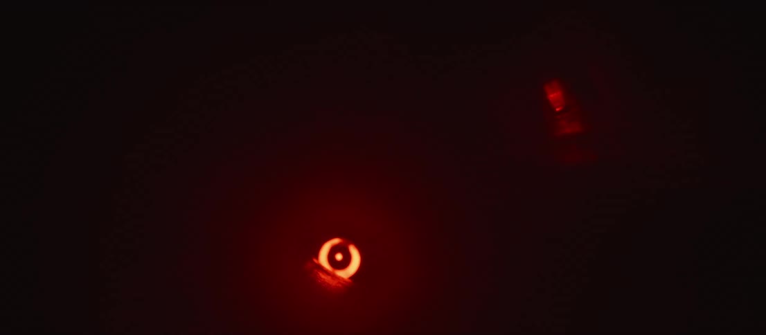A small glowing orb moves in the tunnel