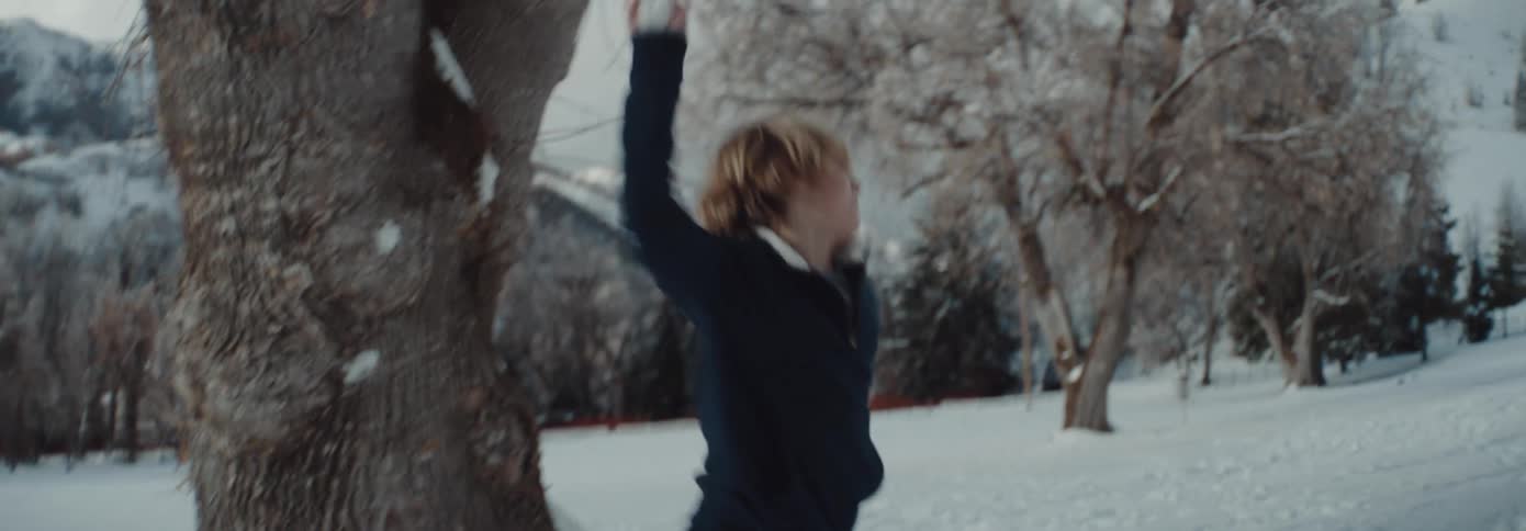 Two children outside having a snowball fight in the snow