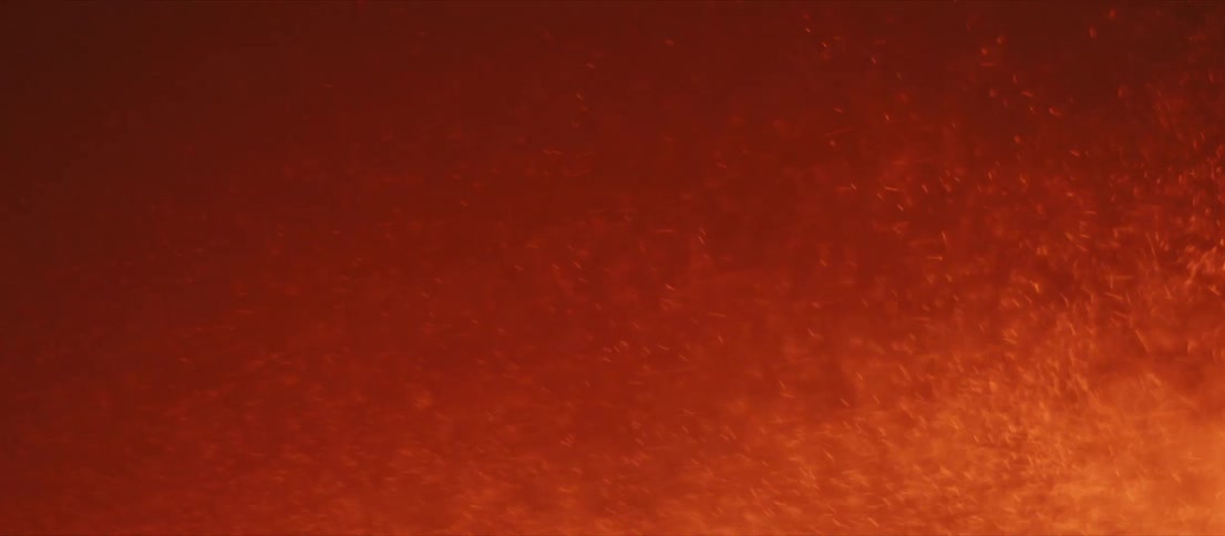 A shower of red hot sparks rushing from left to right on a black background