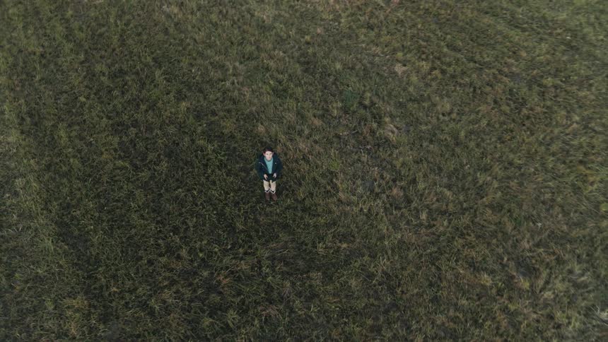 Young child is outside in an open field