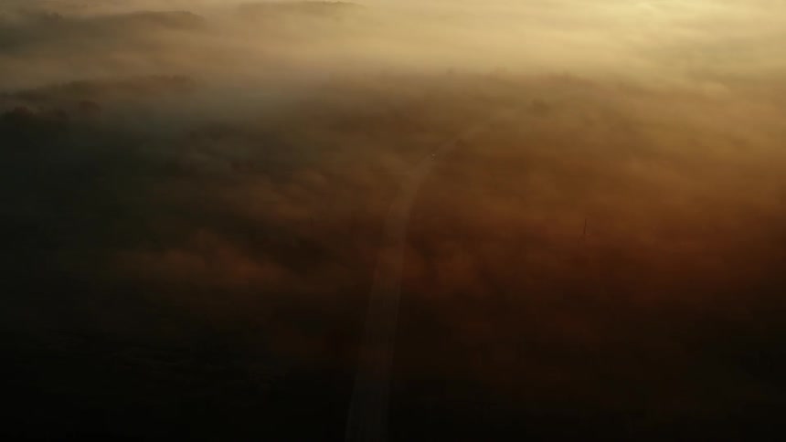 An aerial view of clouds over a road