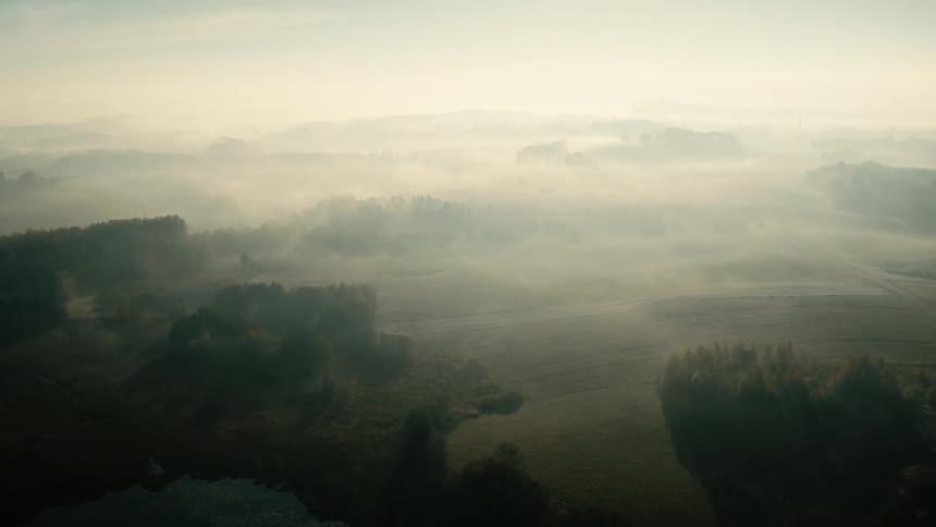 Aerial view of lakes separated by land on a foggy morning