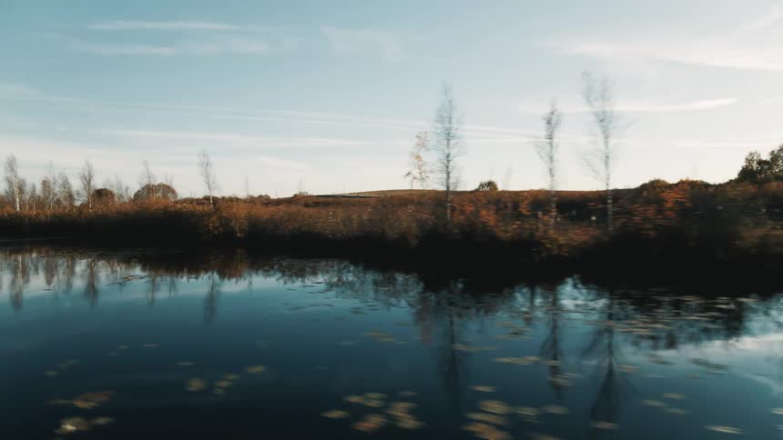 A river next to a flat grassland during the day
