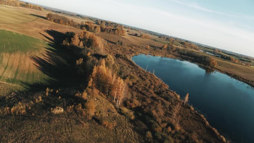 A large rural area with lakes and a lot of grass fields