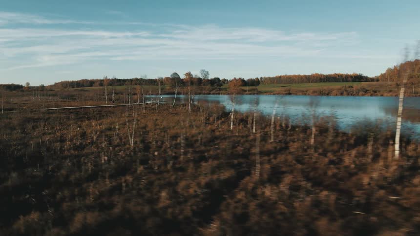 A wet swampy area near a river and land