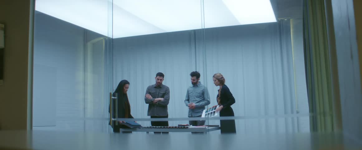 Group of people on a meeting room in an office looking at samples