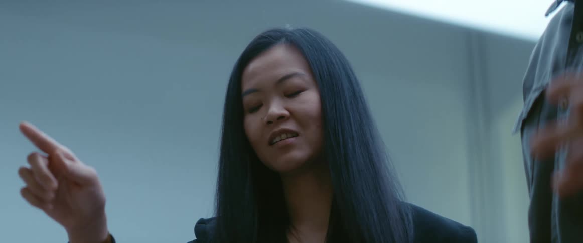 A woman in an office talks with a coworker
