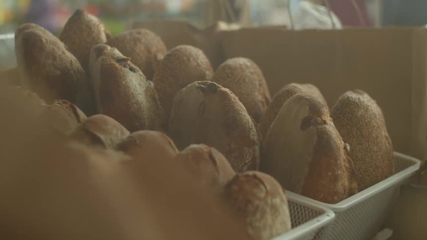 Mesh baskets and paper bags hold breads and pastries