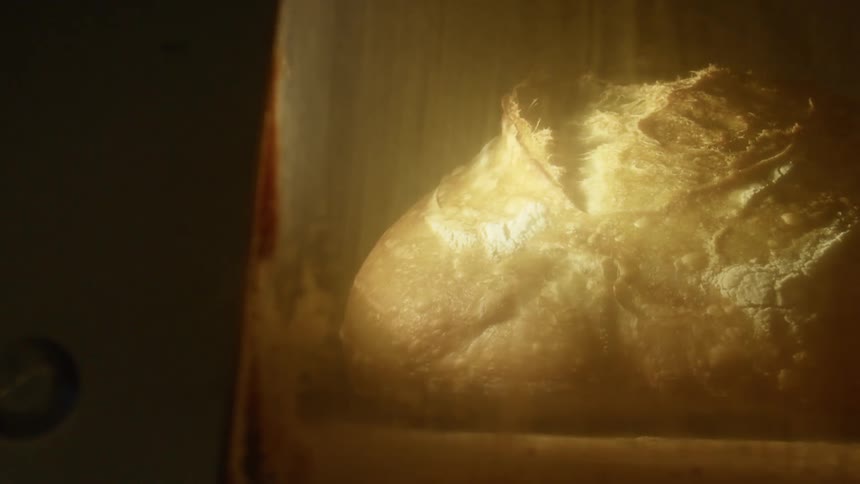 A bread on a shelf with smoke coming off of it