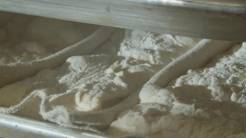 The shelves are filled with white dough and flour