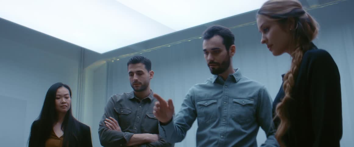 A man in an office talks to coworkers