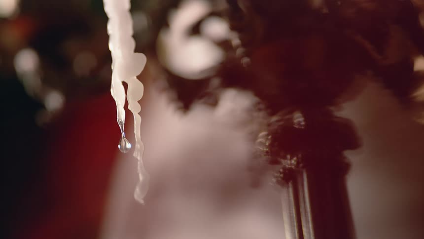 A droplet of water drips off an icicle