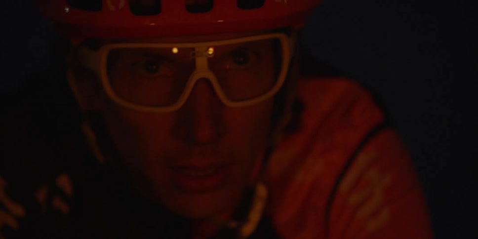 A man wearing goggles and a helmet at night