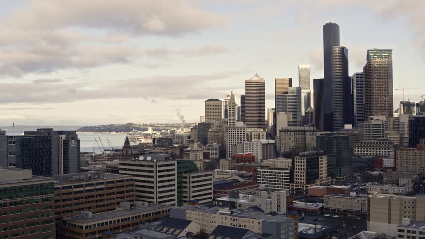 Low traverse over the SoDo district of downtown Seattle at sunrise