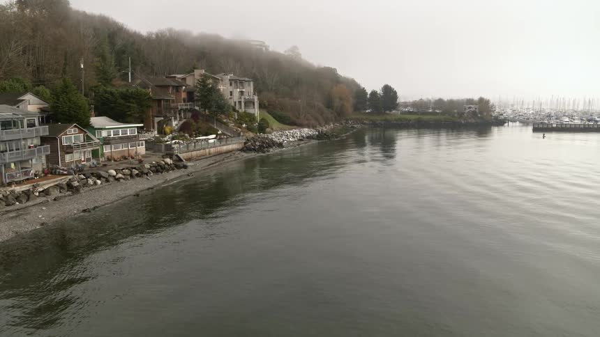 Aerial view of waterfront homes near a fog shrouded marina in the Magnolia neighborhood