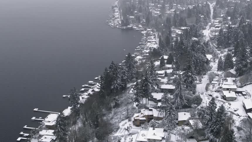 Light snow covers the Sand Point neighborhood along Lake Washington on a cold and misty winter day