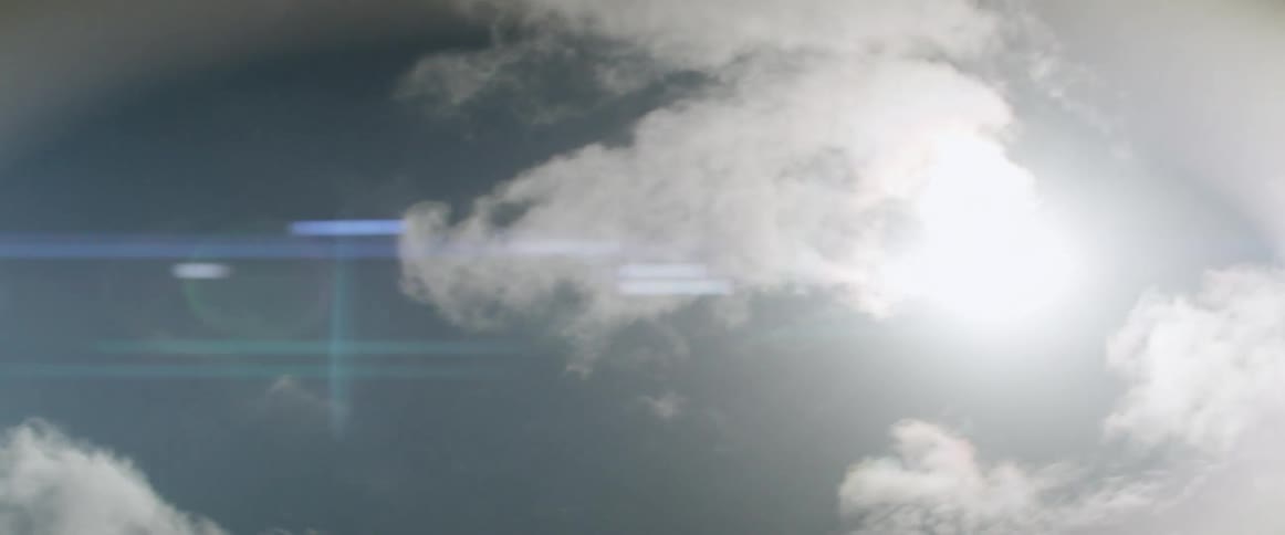 A view of the sun and clouds in the sky