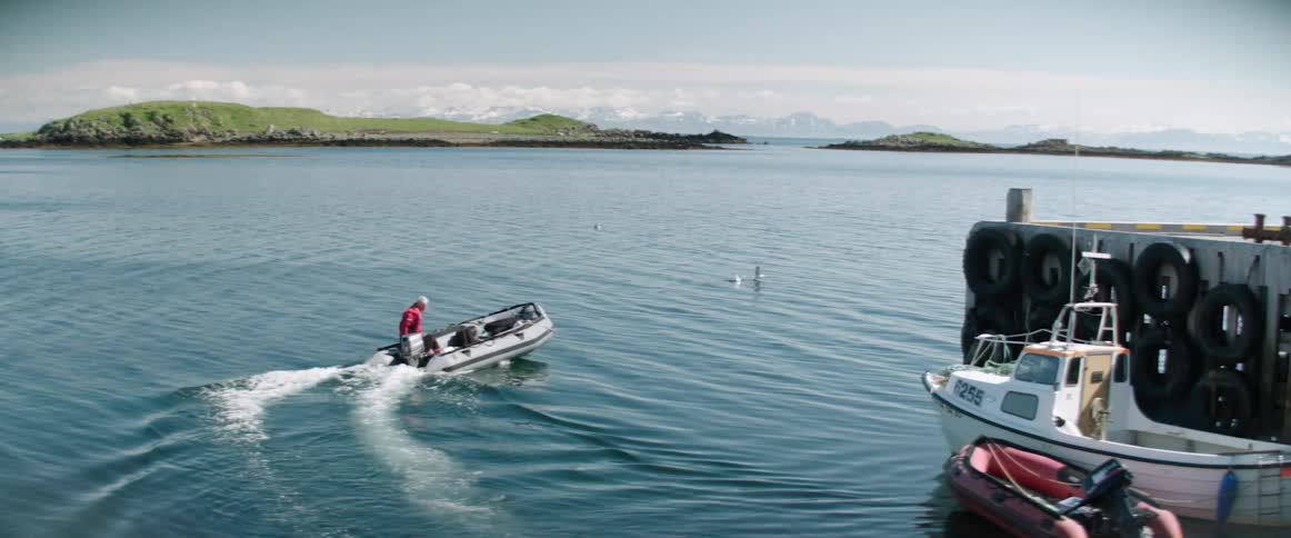 A person driving a boat on a lake