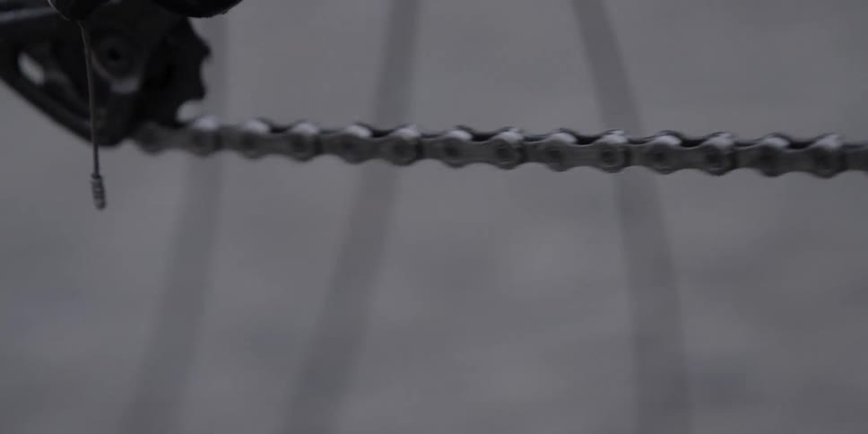 A bike chain and wheels turning