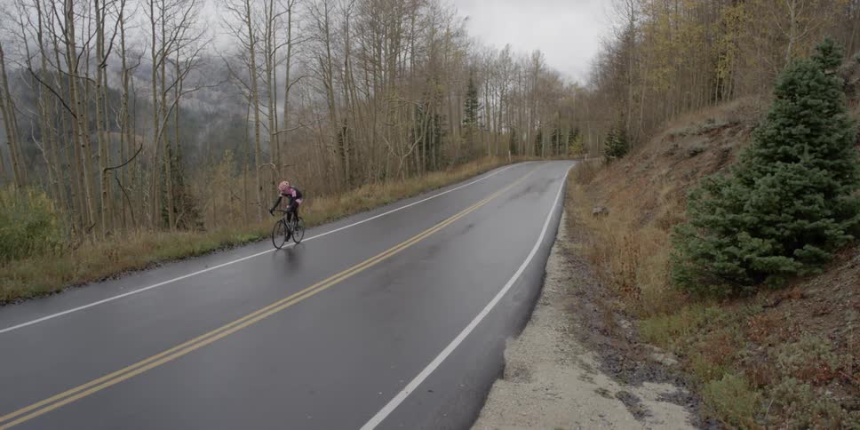 A person is riding a bike down a road