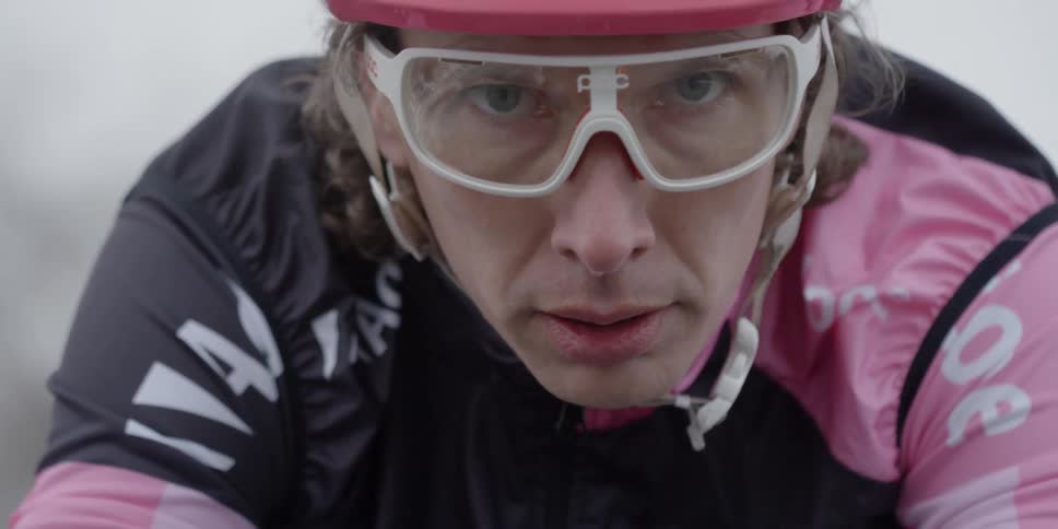 Close-up of a cyclist's face wearing pink and black