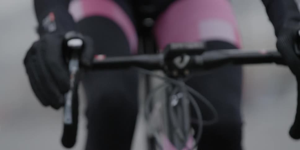 A woman's legs pedals a bike