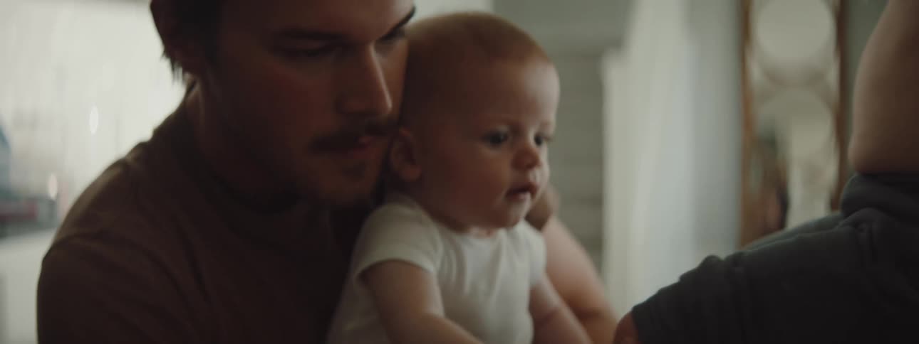 Father working from home takes care of his son injured knee