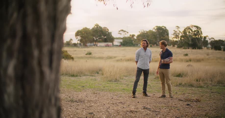 Two men are talking on the field