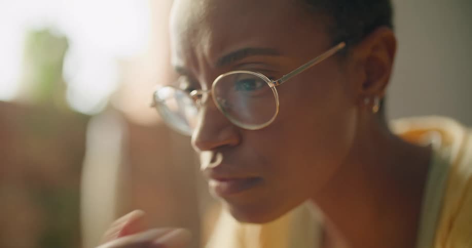 A woman is leaning forward looking at something